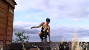 The girl walked along the railway tracks in latex shoes