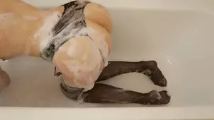 Playful babe cleans her feet and masturbates them