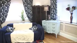 A redhead woman with a bush is fucking on the couch in a steamy scene