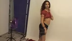 An Indian prostitute is rooted in a sensual outfit on the couch